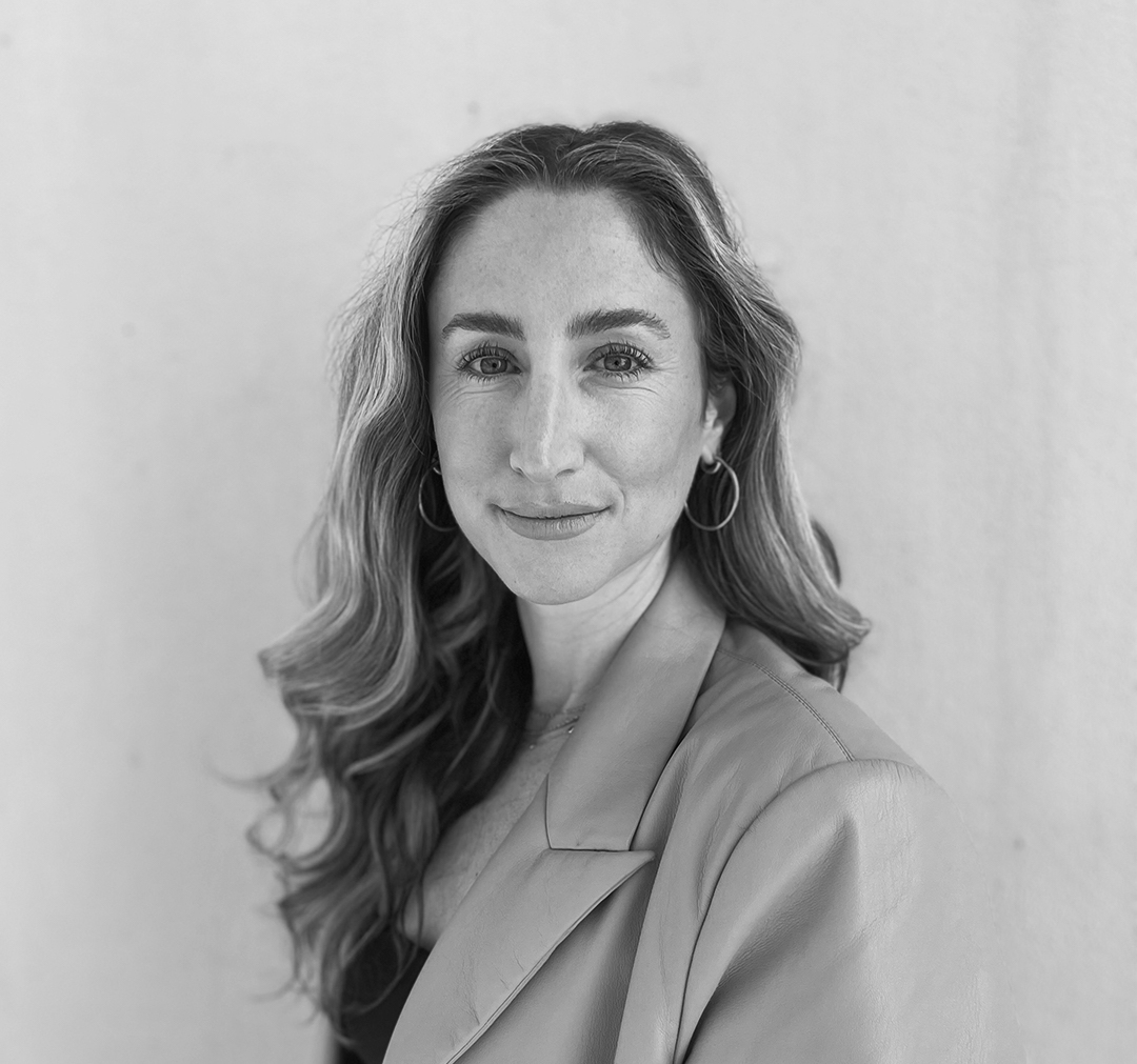 black and white photo of woman turned towards the camera. 