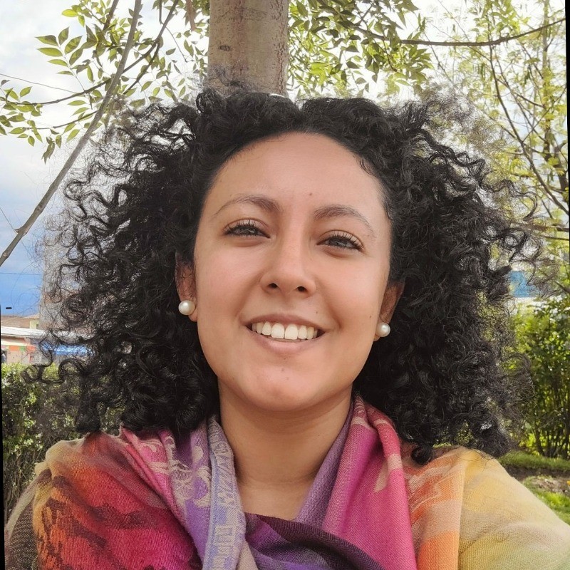 Smiling person with curly hair. 